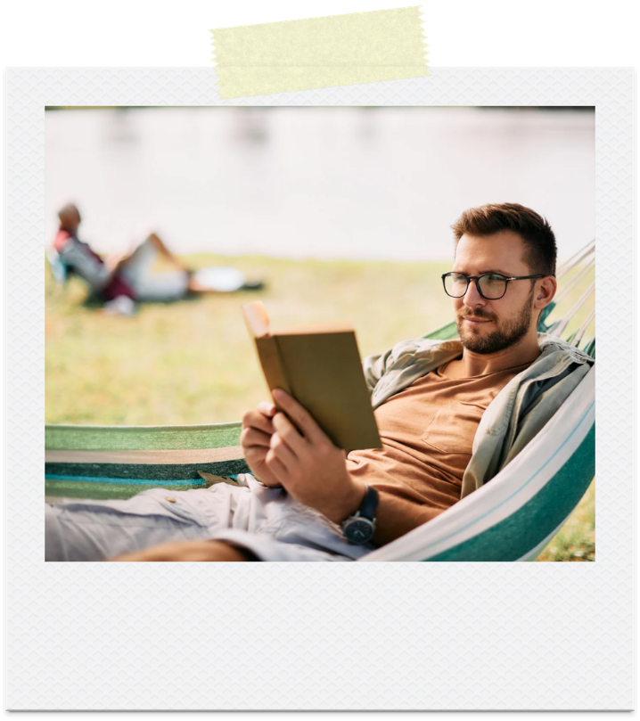 A man reading in a hammock outdoors